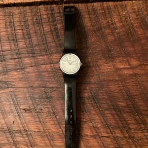 Black band swatch watch with green hands and white face